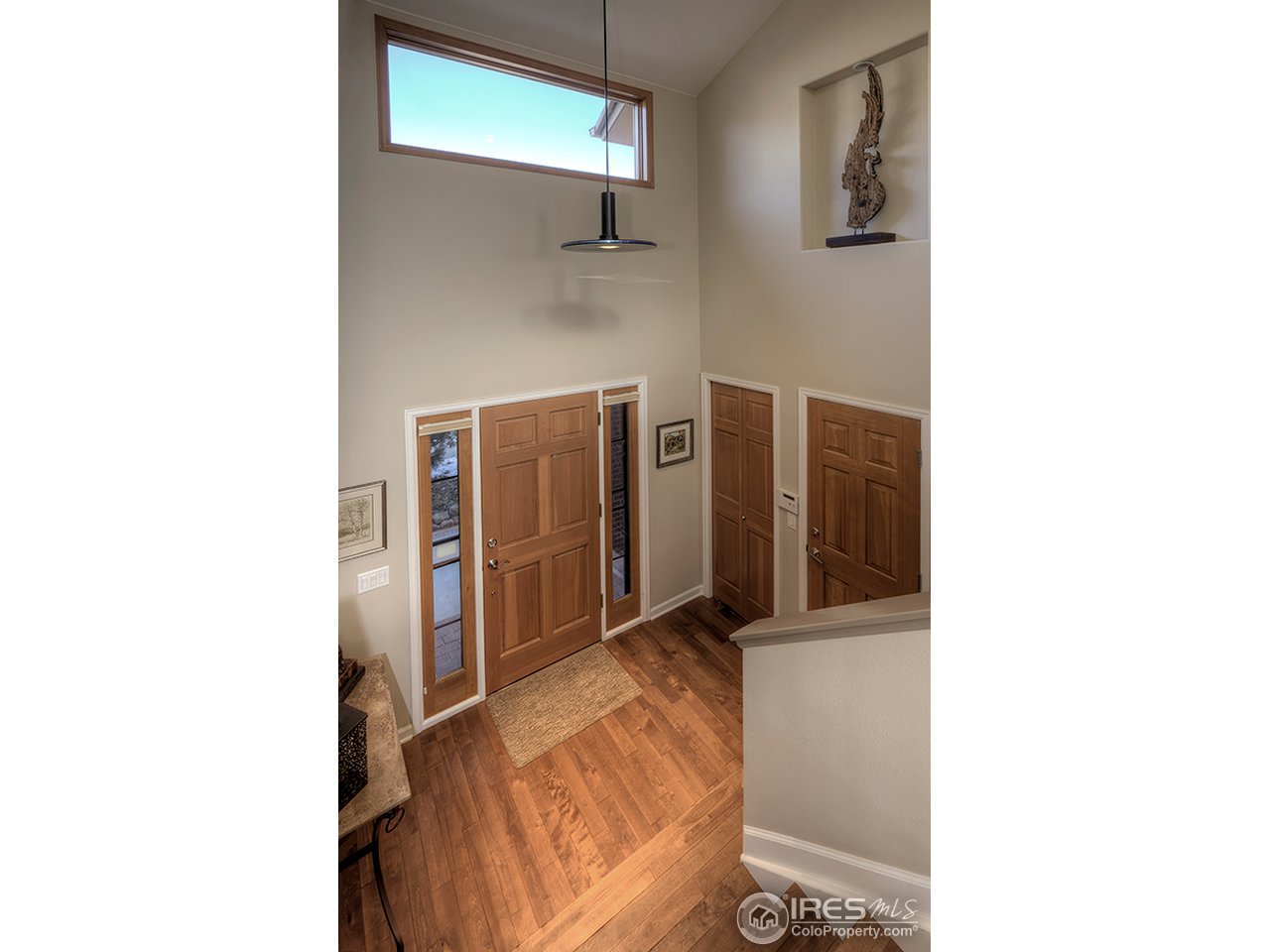 3180 Redstone Road Boulder, CO 80305 - Photo 18 of 24 a picture of a room with a door and a white refrigerator