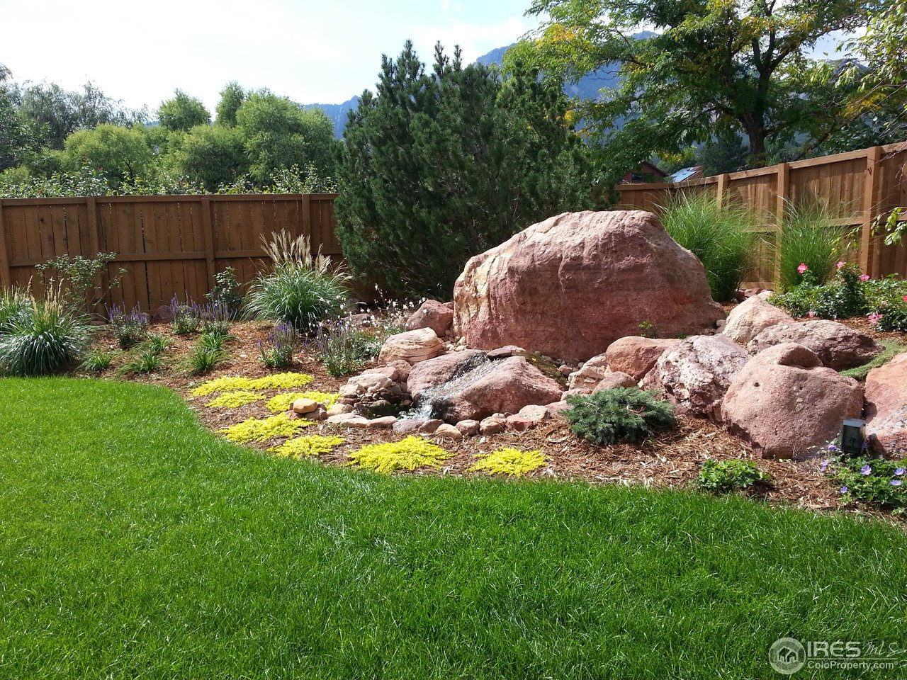 3180 Redstone Road Boulder, CO 80305 - Photo 21 of 24 a backyard of a house with lots of green space