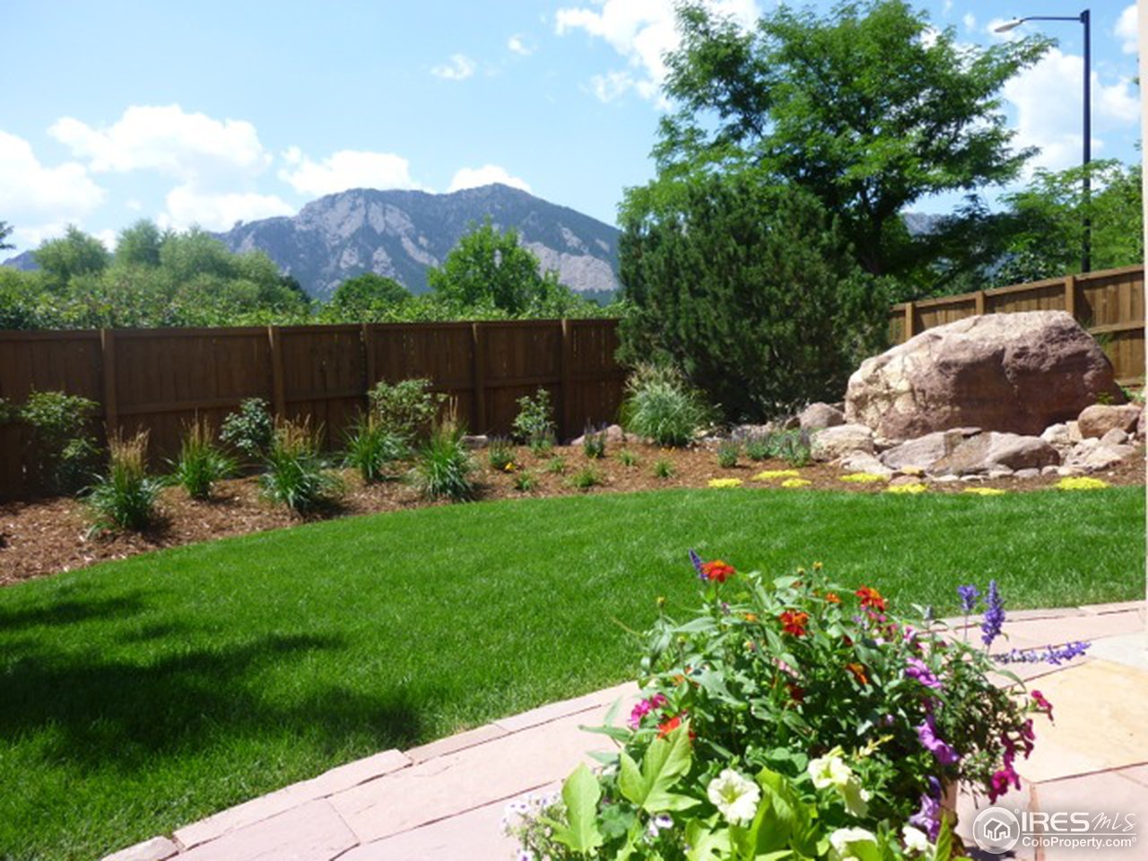 3180 Redstone Road Boulder, CO 80305 - Photo 24 of 24 a garden with flowers and a bench