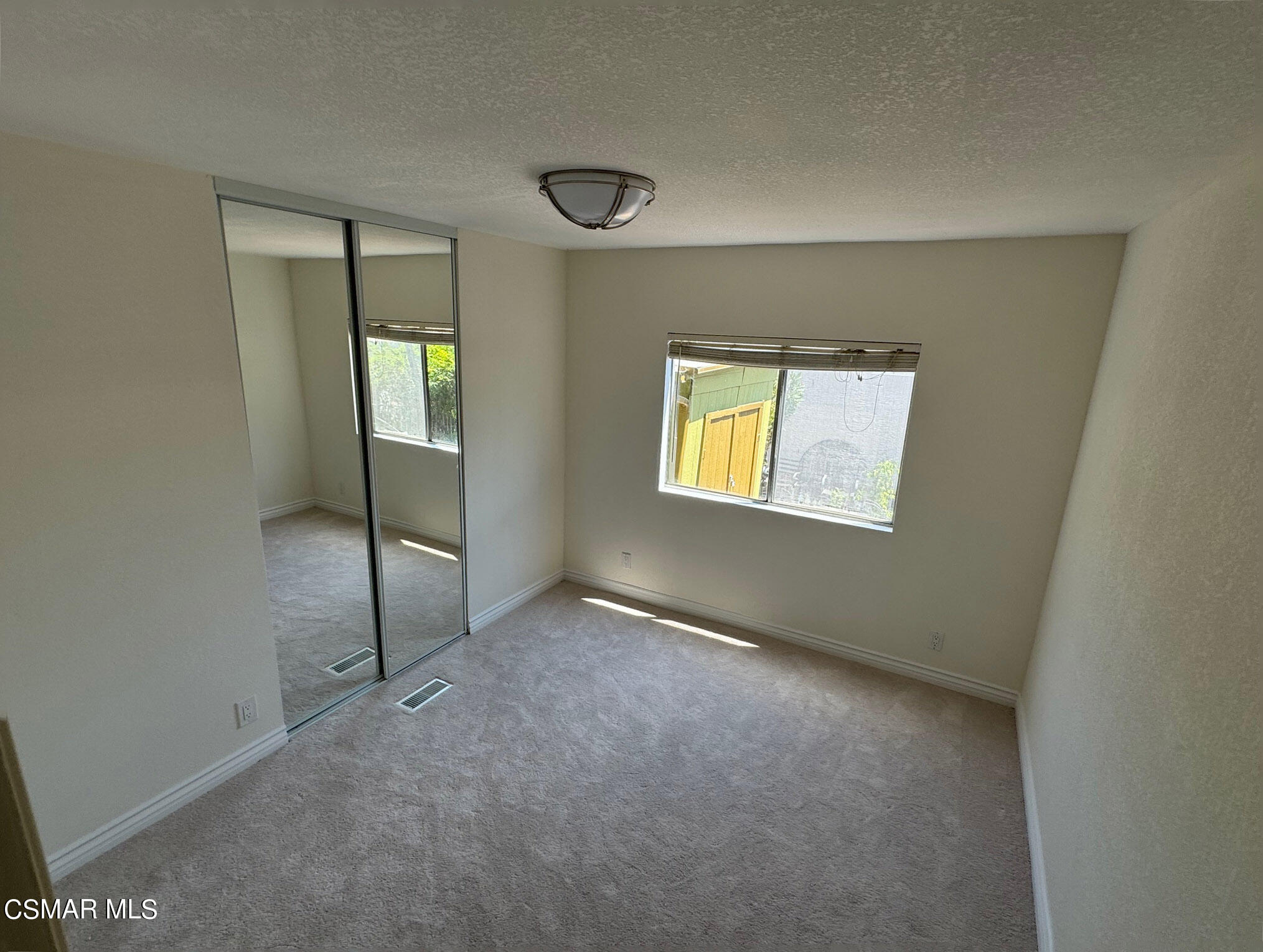 24303 Woolsey Canyon Road, Unit 26 Canoga Park, CA 91304 - Photo 11 of 28 an empty room with windows and closet
