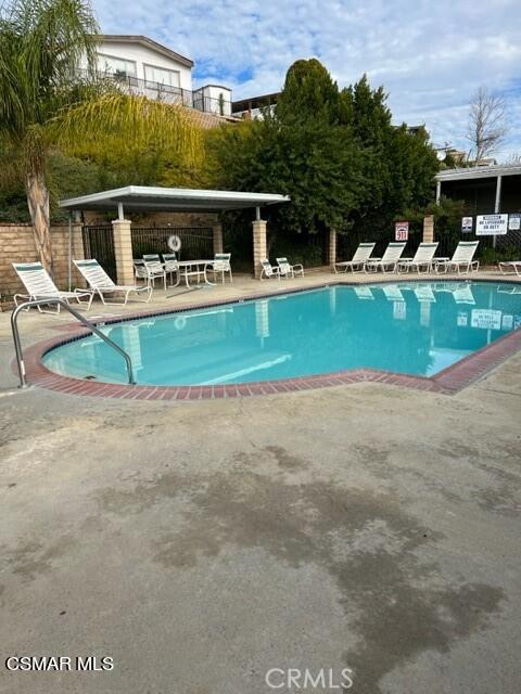 24303 Woolsey Canyon Road, Unit 26 Canoga Park, CA 91304 - Photo 23 of 28 a view of a house with a swimming pool