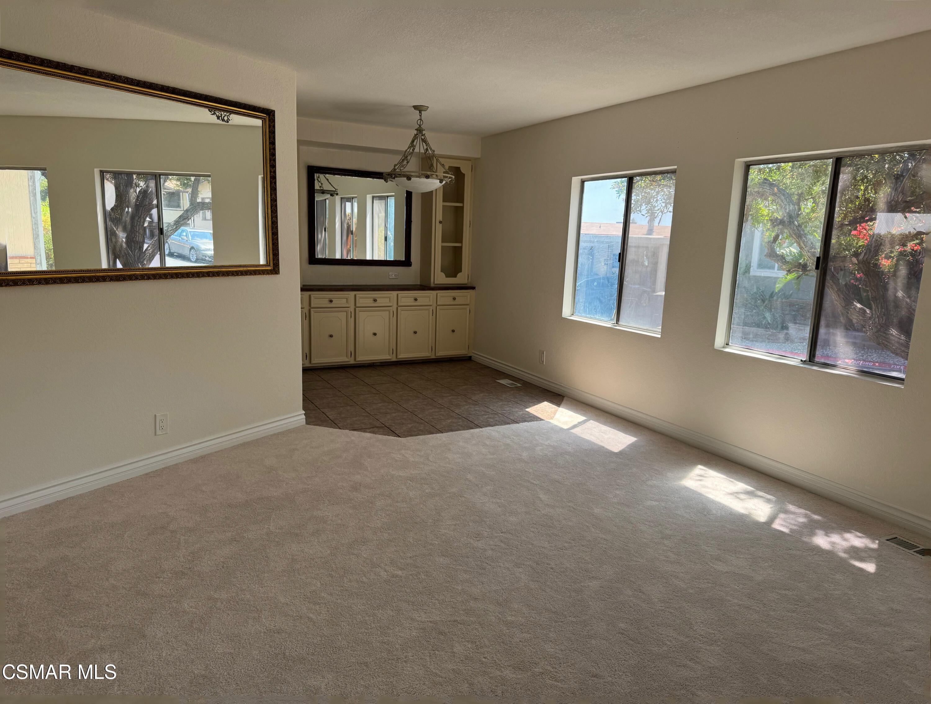 24303 Woolsey Canyon Road, Unit 26 Canoga Park, CA 91304 - Photo 4 of 28 an empty room with windows and cabinet