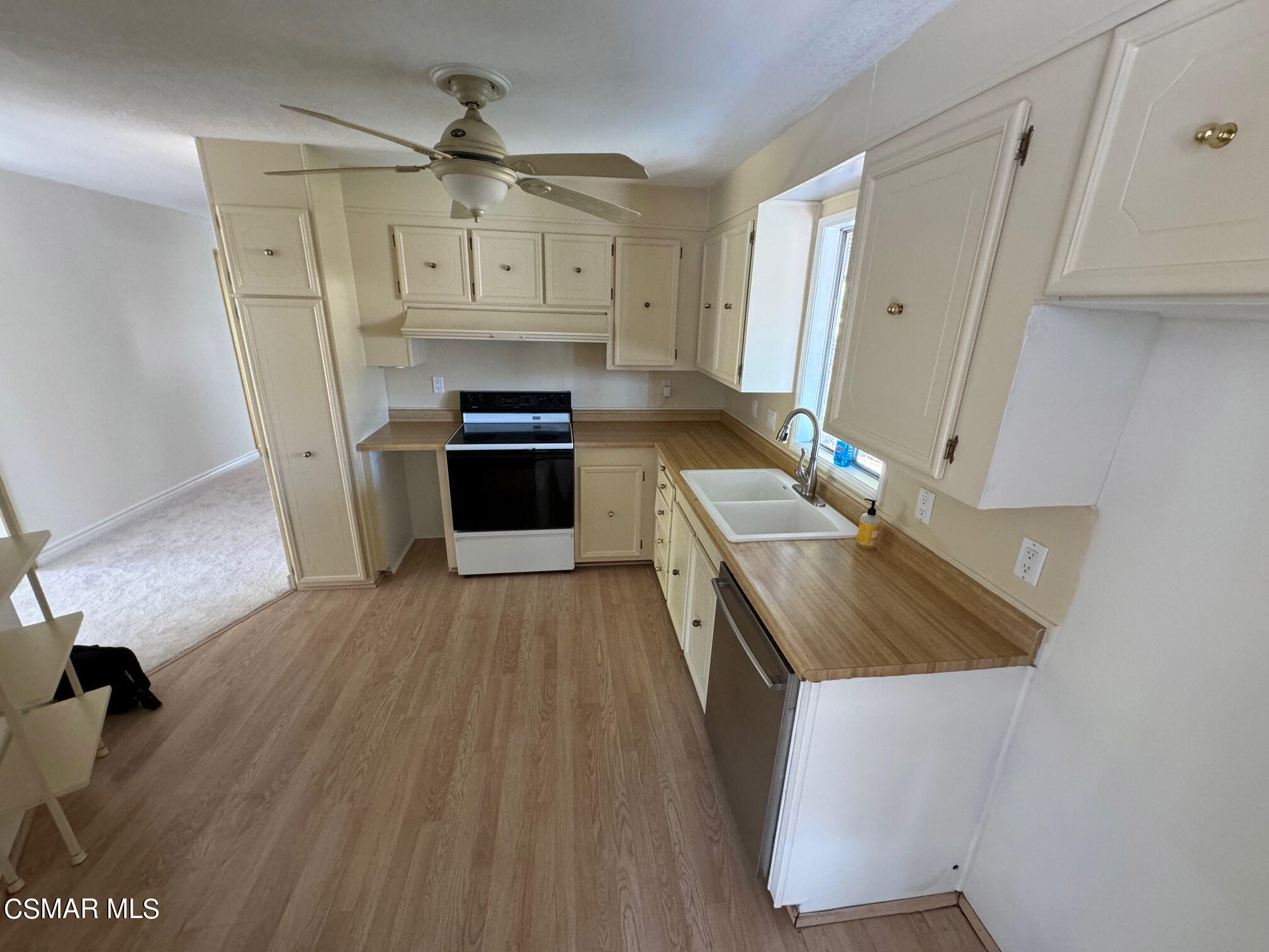 24303 Woolsey Canyon Road, Unit 26 Canoga Park, CA 91304 - Photo 6 of 28 a kitchen with a sink appliances and cabinets