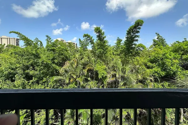 a view of a chairs and table in the balcony