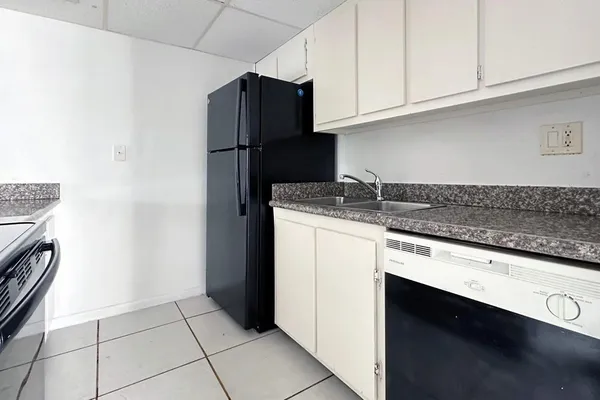 a kitchen with a sink and a refrigerator
