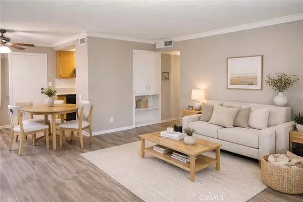 a living room with furniture and wooden floor