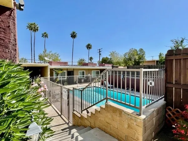 a view of a house with wooden deck and furniture