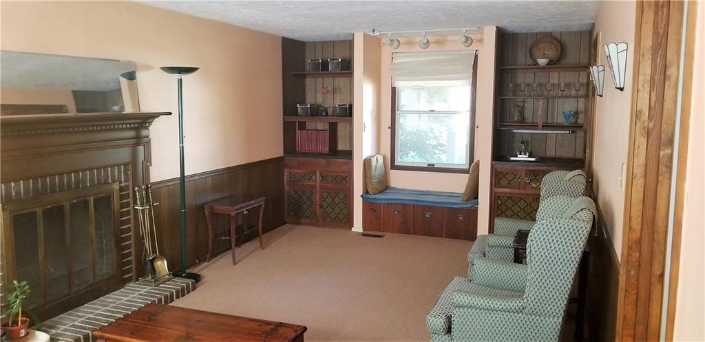 2177 Ramsey Road Monroeville, PA 15146 - Photo 11 of 25 Here we step into the family room. It features a fireplace, a wet bar, built in storage, and a window seat, perfectly placed to enjoy the cottage garden out front or simply sit and watch the world go by.