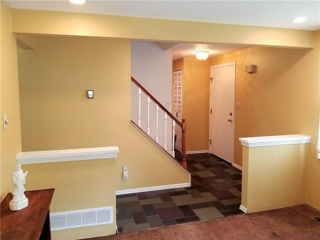 The entryway features a ceramic tile floor and a convenient coat closet near the front door.