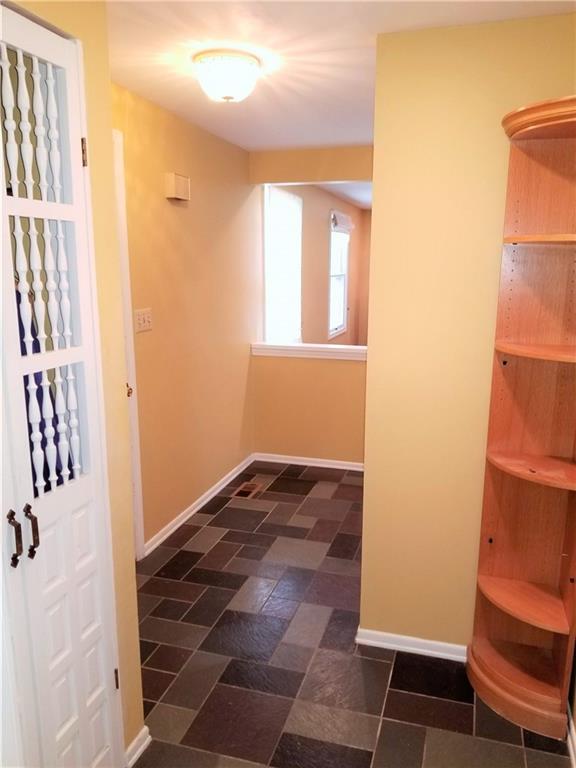 A reverse view of the entryway. The coat closet is on the left, additional storage and powder room door on the right.
