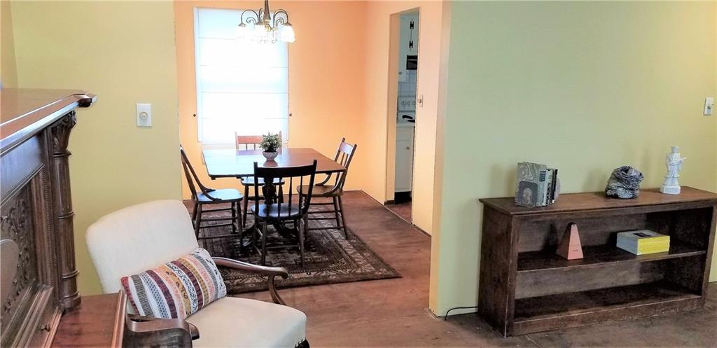A look from the living room into the dining room. Both are just waiting for you to pick your own new flooring for a personalized final touch.