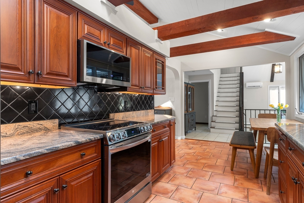 9 School Street Boxford, MA 01921 - Photo 10 of 38 a kitchen with stainless steel appliances granite countertop a stove and a microwave