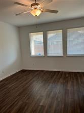 719 Biscay Way Princeton, TX 75407 - Photo 4 of 24 a view of an empty room with wooden floor and a window