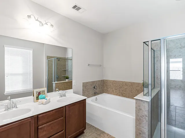a bathroom with a bathtub and shower