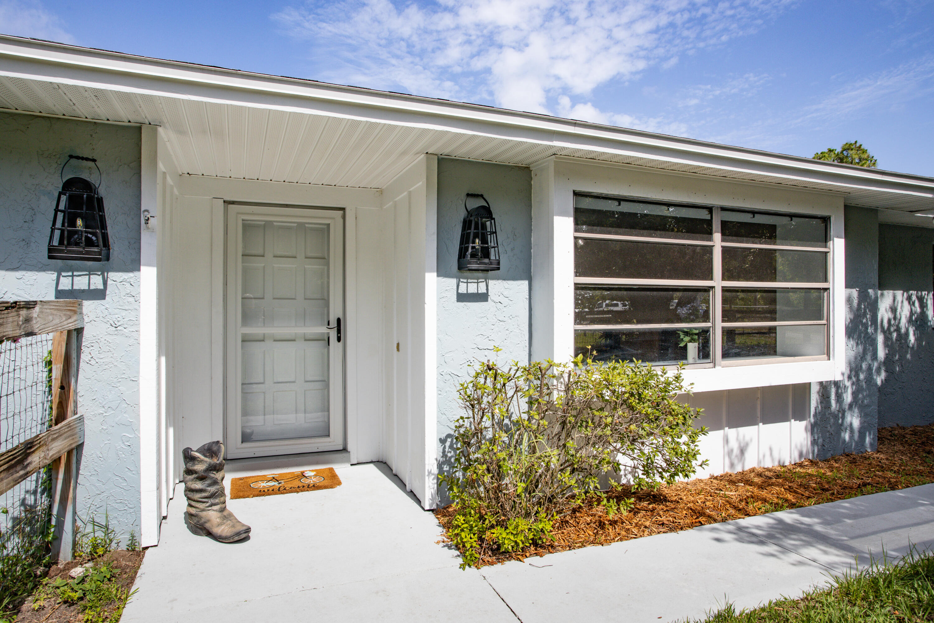 1280 Corey Road Malabar, FL 32950 - Photo 2 of 56 a front view of a house with a yard