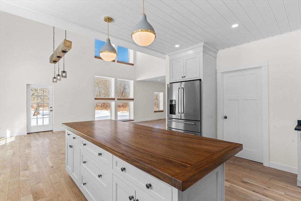 7 Justin Circle York, ME 03909 - Photo 10 of 36 a room with kitchen island a wooden floor and window