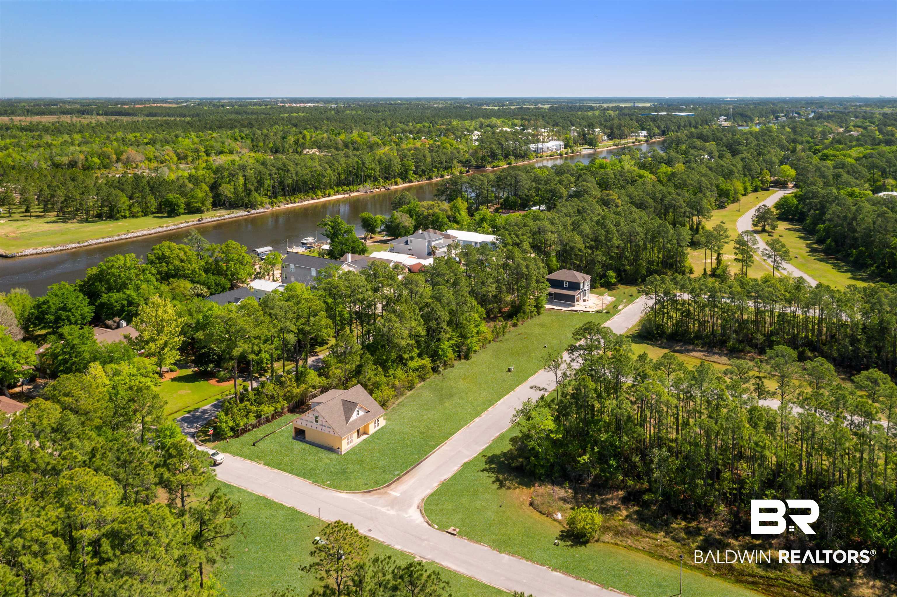 657 Island Way Gulf Shores, AL 36542 - Photo 42 of 59 Drone / aerial view featuring a wooded view and a water view