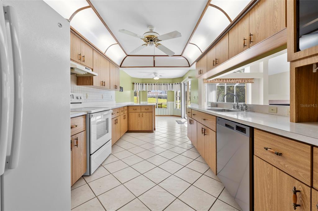 1446 Cornell Avenue Spring Hill, FL 34609 - Photo 11 of 39 a large kitchen with a sink and cabinets