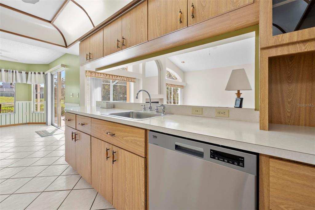 1446 Cornell Avenue Spring Hill, FL 34609 - Photo 12 of 39 a kitchen with stainless steel appliances granite countertop a sink and a white cabinets