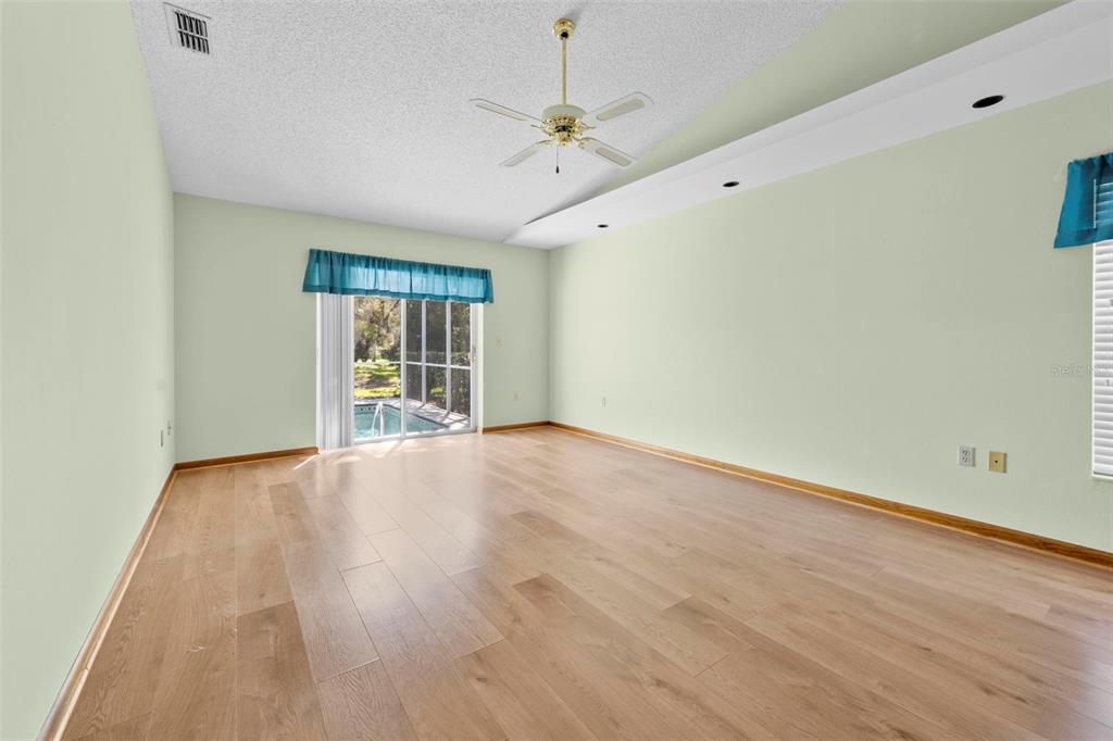 1446 Cornell Avenue Spring Hill, FL 34609 - Photo 17 of 39 a view of an empty room with a window and wooden floor