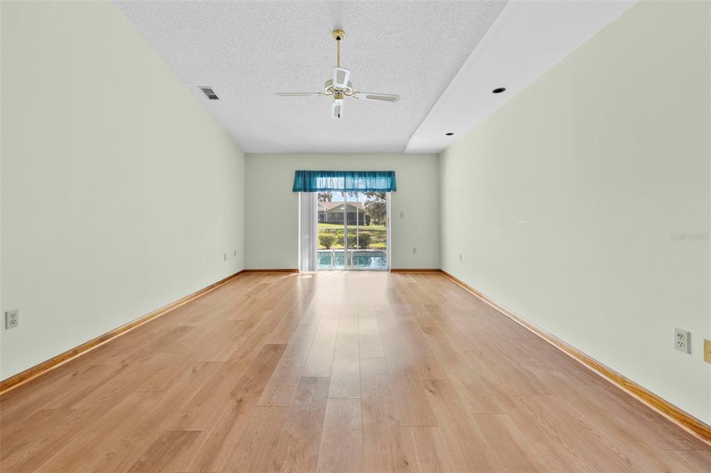 1446 Cornell Avenue Spring Hill, FL 34609 - Photo 18 of 39 wooden floor in an empty room with a window