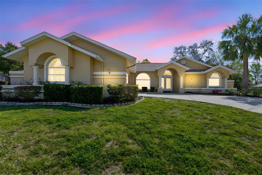 1446 Cornell Avenue Spring Hill, FL 34609 - Photo 2 of 39 a front view of a house with garden