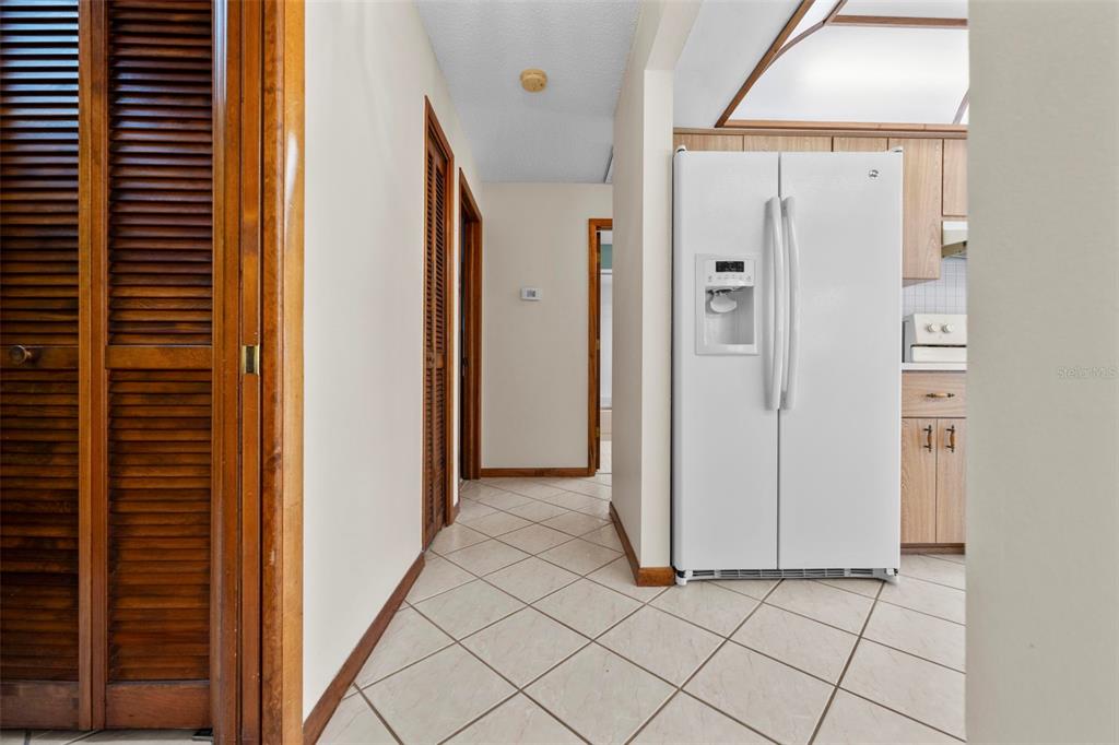1446 Cornell Avenue Spring Hill, FL 34609 - Photo 23 of 39 a view of a hallway with wooden shelves