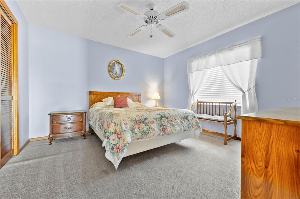 1446 Cornell Avenue Spring Hill, FL 34609 - Photo 25 of 39 a bedroom with a bed and a window