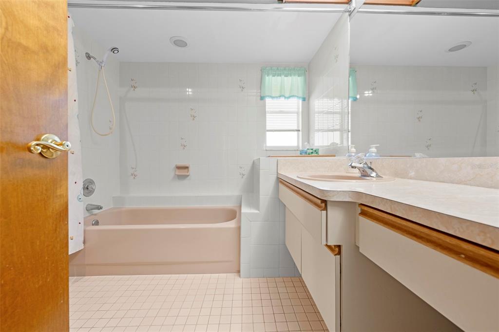 1446 Cornell Avenue Spring Hill, FL 34609 - Photo 27 of 39 a bathroom with a sink a toilet a tub and shower