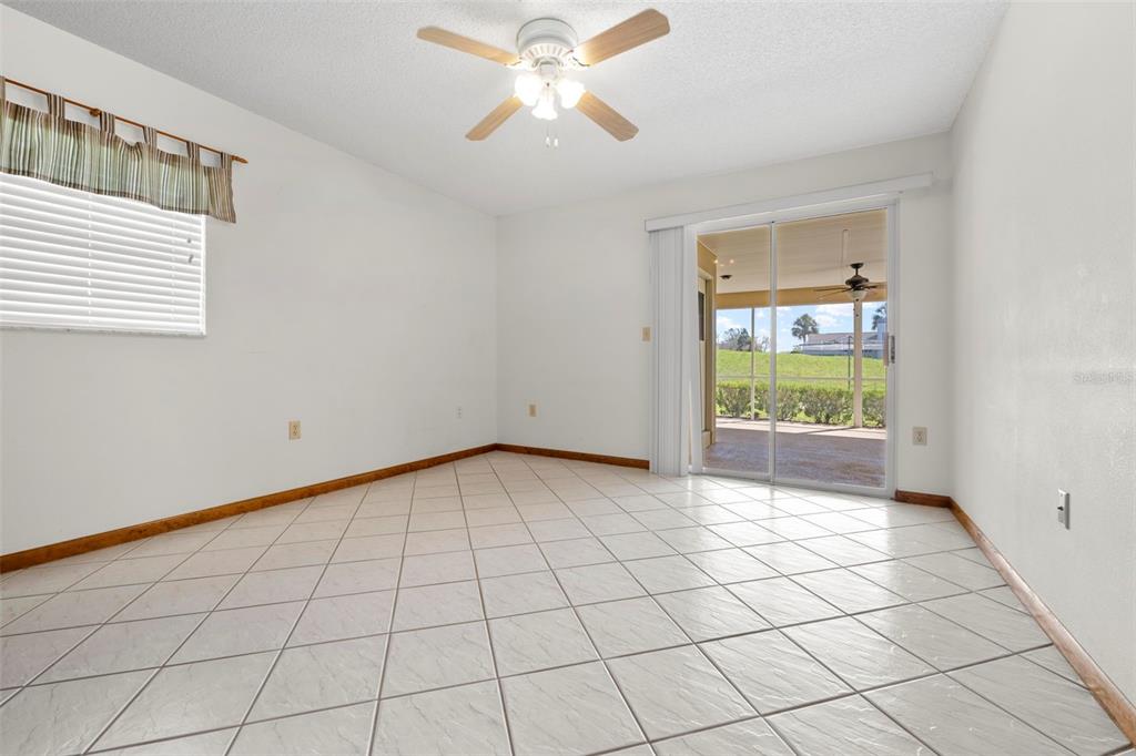 1446 Cornell Avenue Spring Hill, FL 34609 - Photo 28 of 39 a view of an empty room and window & chandelier fan
