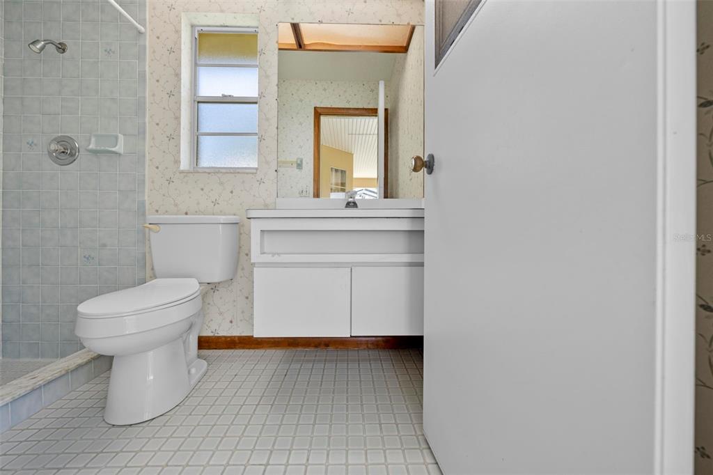 1446 Cornell Avenue Spring Hill, FL 34609 - Photo 30 of 39 a bathroom with a toilet sink and mirror