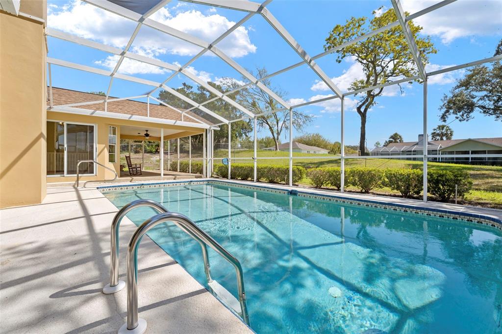 1446 Cornell Avenue Spring Hill, FL 34609 - Photo 34 of 39 a view of a swimming pool with a patio and a yard