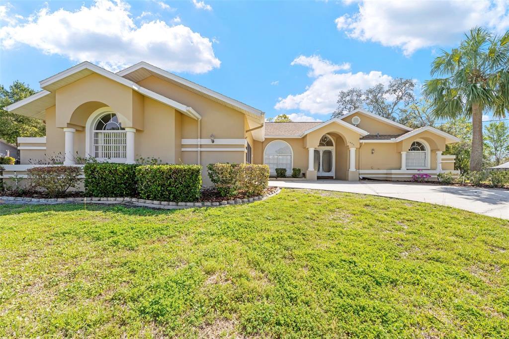 1446 Cornell Avenue Spring Hill, FL 34609 - Photo 38 of 39 a front view of a house with a yard