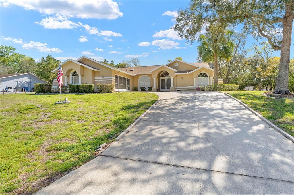 1446 Cornell Avenue Spring Hill, FL 34609 - Photo 39 of 39 a front view of a house with a yard