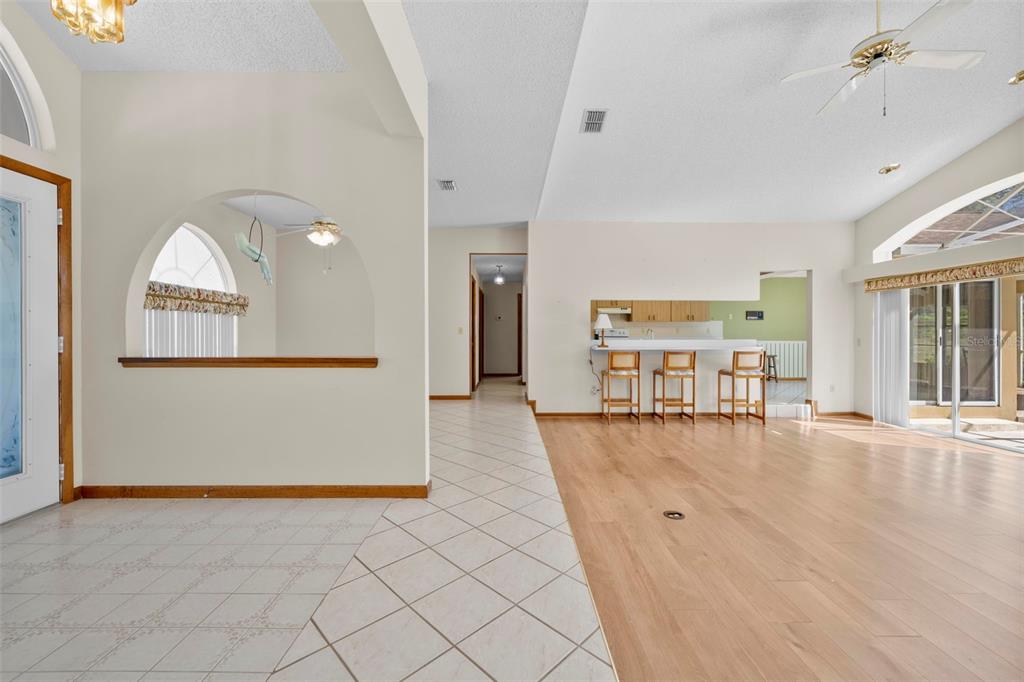 1446 Cornell Avenue Spring Hill, FL 34609 - Photo 4 of 39 an empty room with wooden floor and windows