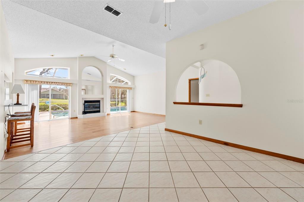 1446 Cornell Avenue Spring Hill, FL 34609 - Photo 7 of 39 an empty room with windows and way to kitchen