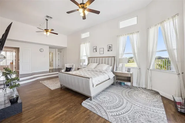 a bedroom with a bed and a chandelier