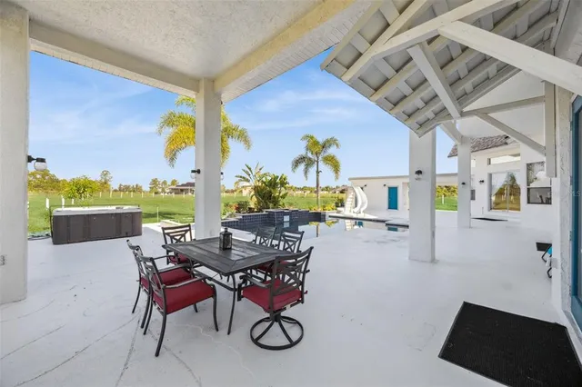 a view of a swimming pool with a patio and a garden