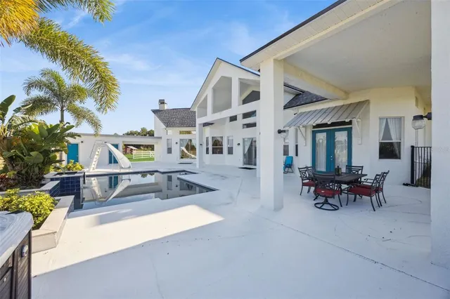 a front view of a house with a garden and trees