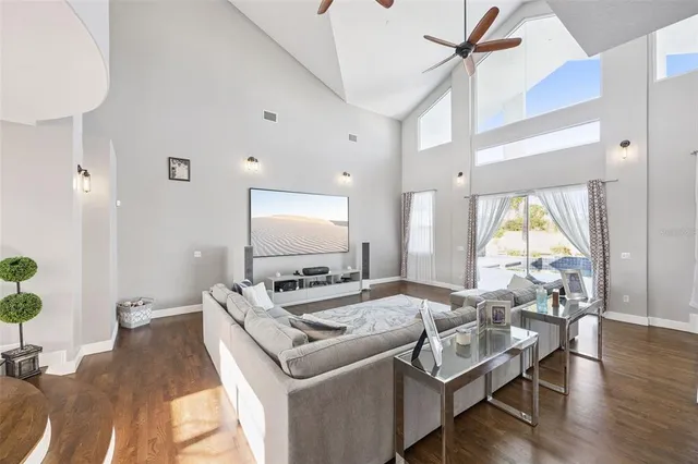 a living room with furniture and a chandelier