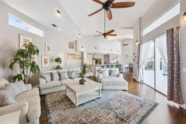 a living room with furniture a fireplace and a chandelier