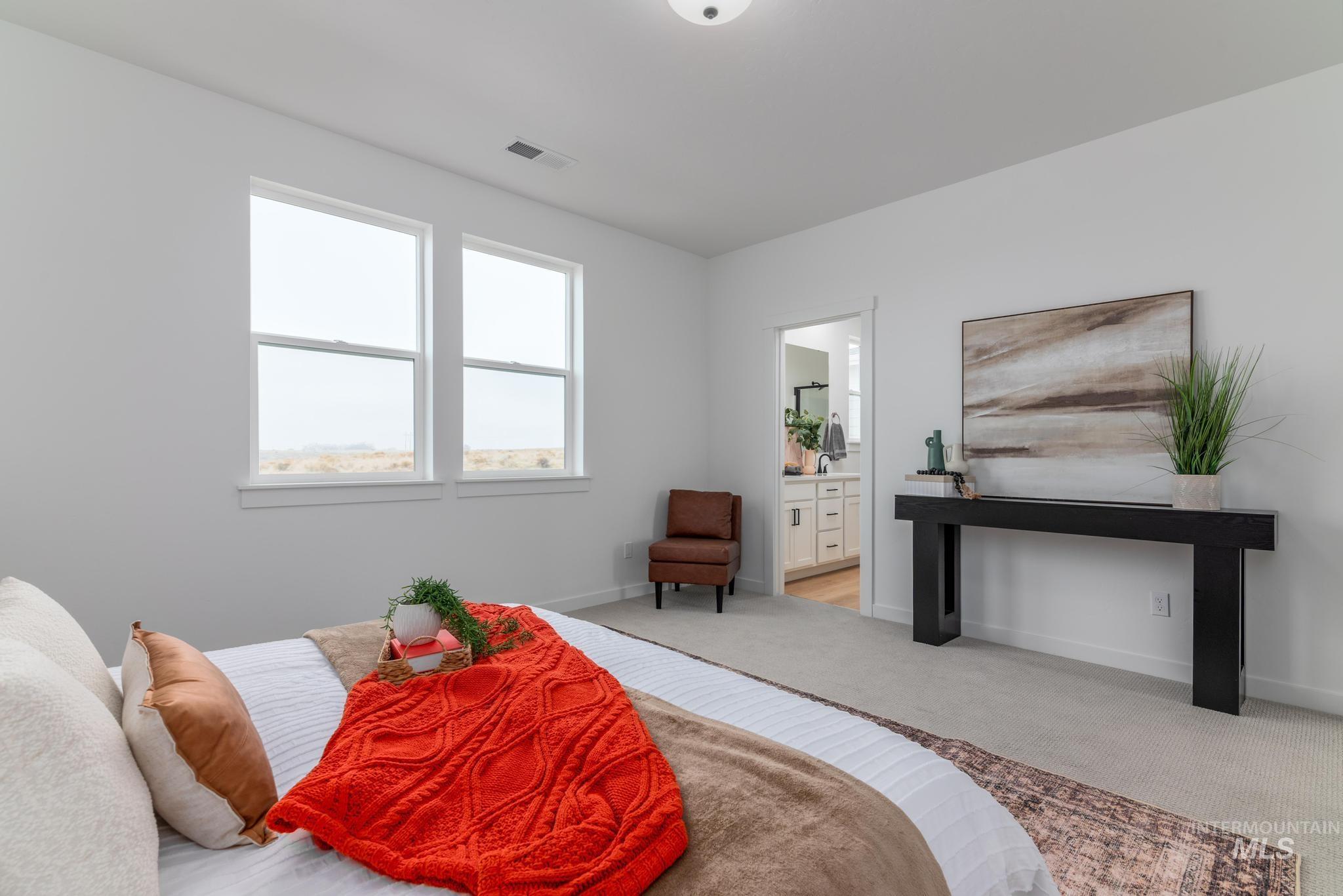 14726 Wing Spread Drive Caldwell, ID 83607 - Photo 18 of 35 Bedroom with light colored carpet and ensuite bathroom