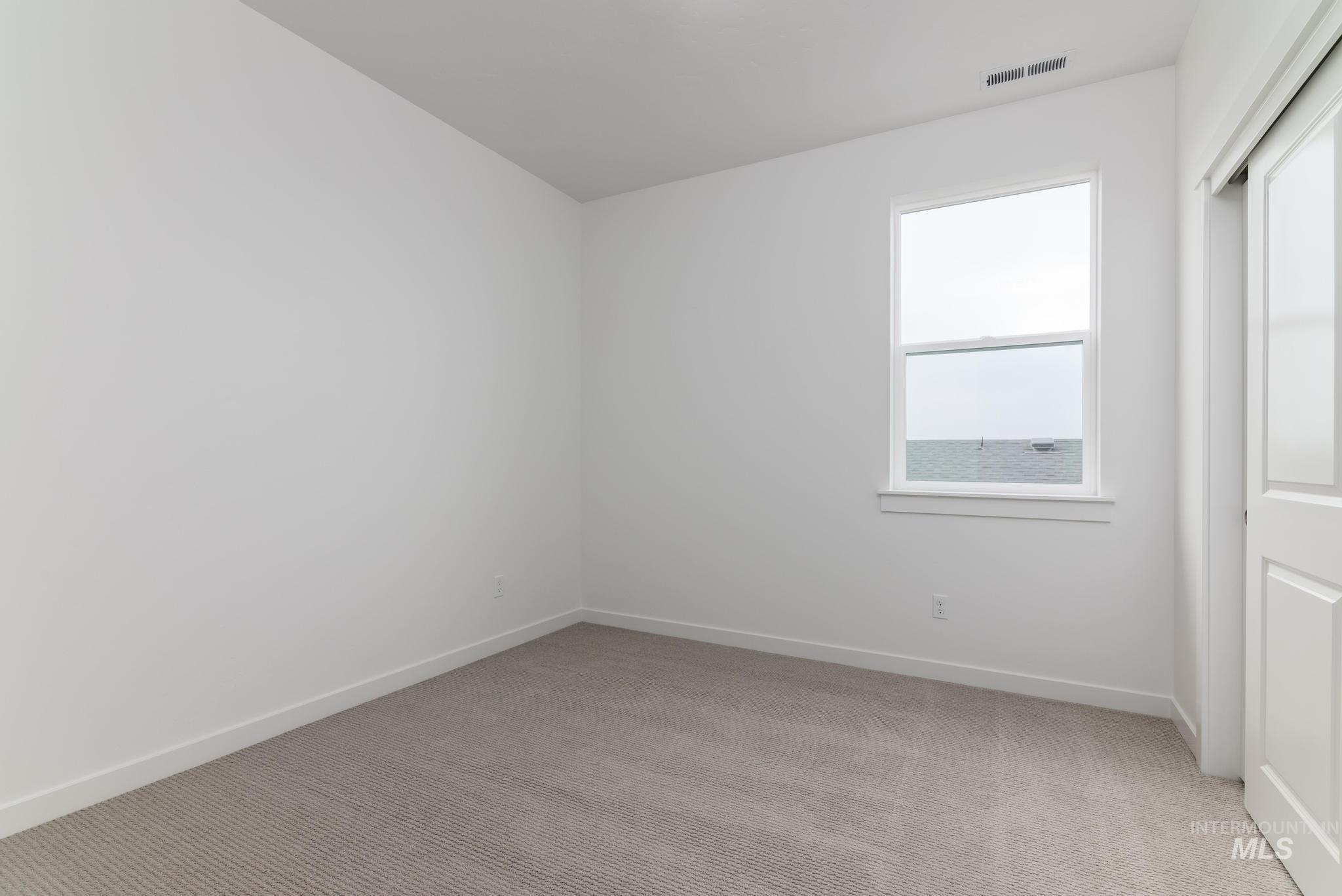 14726 Wing Spread Drive Caldwell, ID 83607 - Photo 20 of 35 Unfurnished bedroom featuring light carpet and a closet