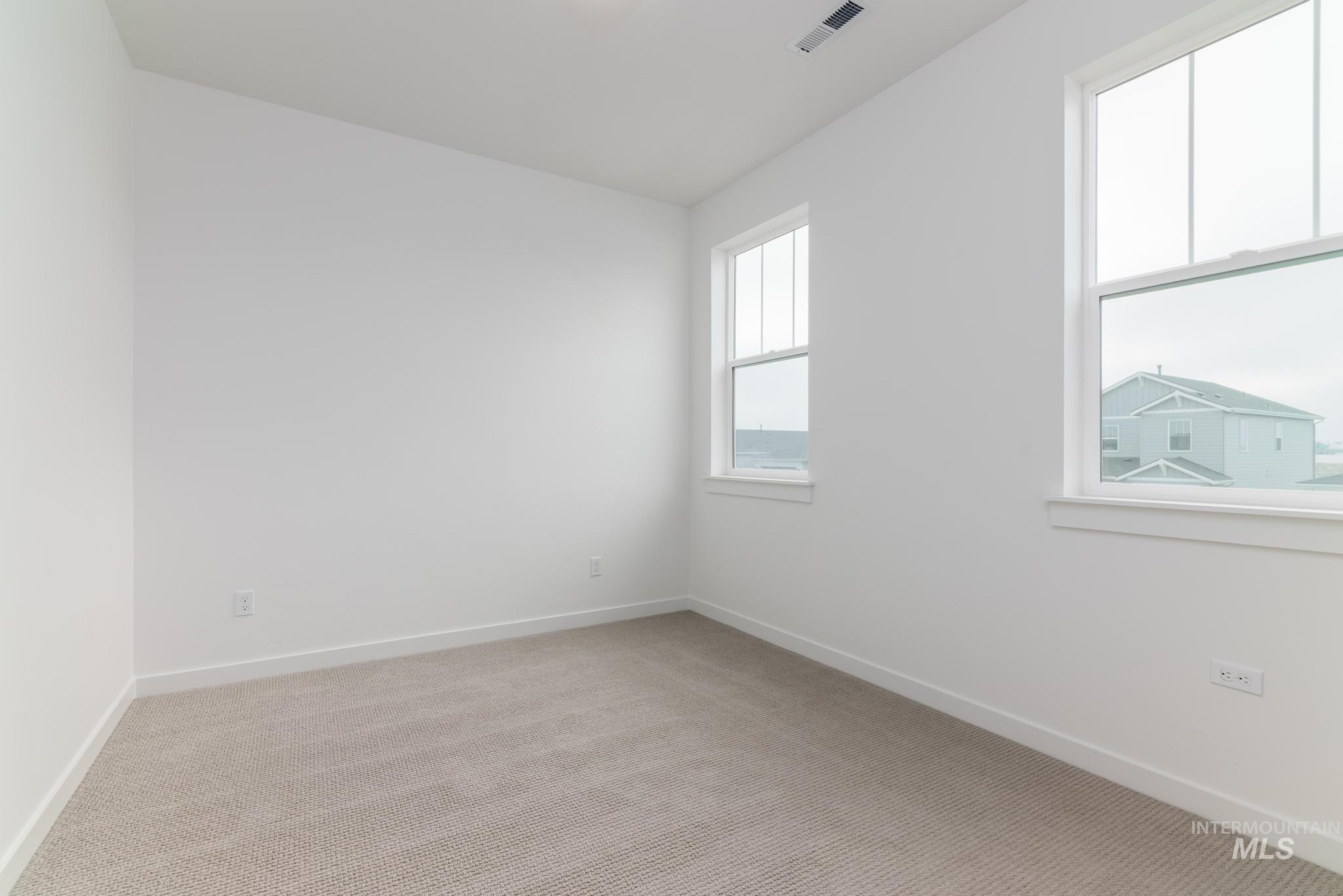 14726 Wing Spread Drive Caldwell, ID 83607 - Photo 21 of 35 Spare room featuring light carpet and baseboards