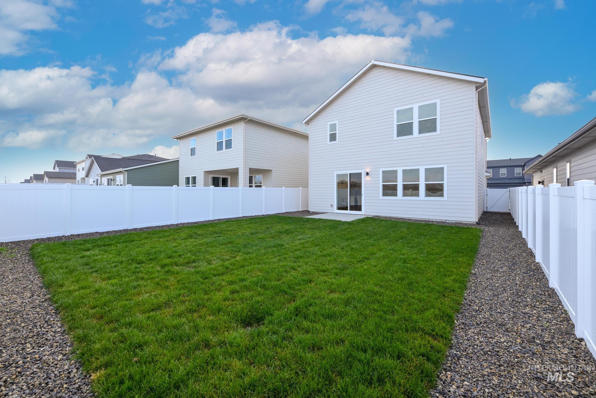14726 Wing Spread Drive Caldwell, ID 83607 - Photo 24 of 35 Rear view of house featuring a fenced backyard and a patio area