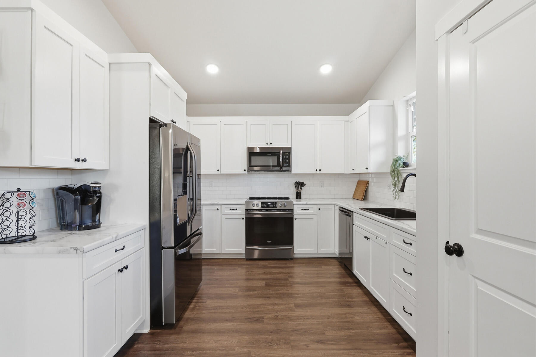 16455 Bassett Road La Pine, OR 97739 - Photo 9 of 44 a kitchen with cabinets stainless steel appliances and wooden floor