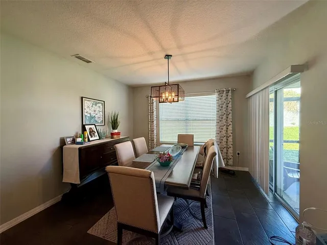 a dining room with furniture and window