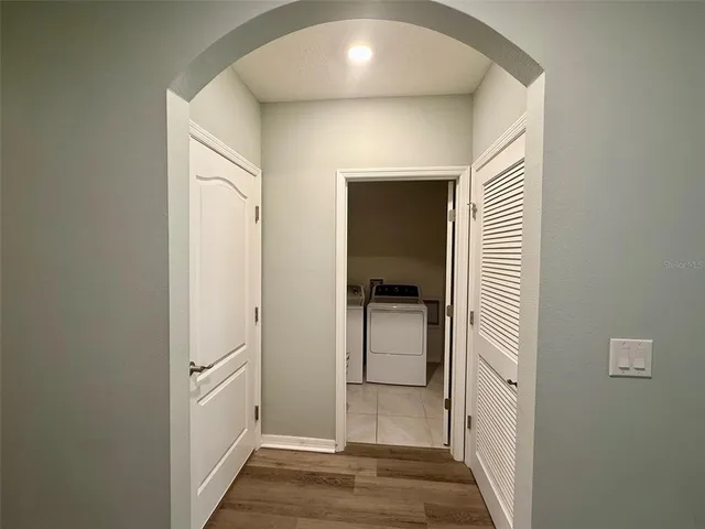 a view of a hallway with a dining room