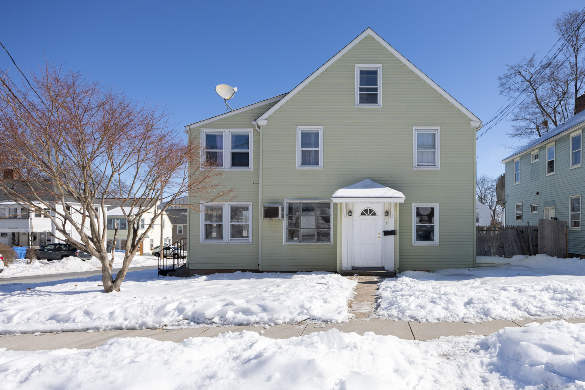 5 Edgewood Street Bristol, CT 06010 - Photo 1 of 1 a front view of a house with a yard covered in snow