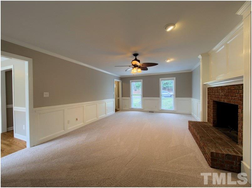 2521 Village Grove Road Raleigh, NC 27613 - Photo 13 of 25 a view of a livingroom with a fireplace and window